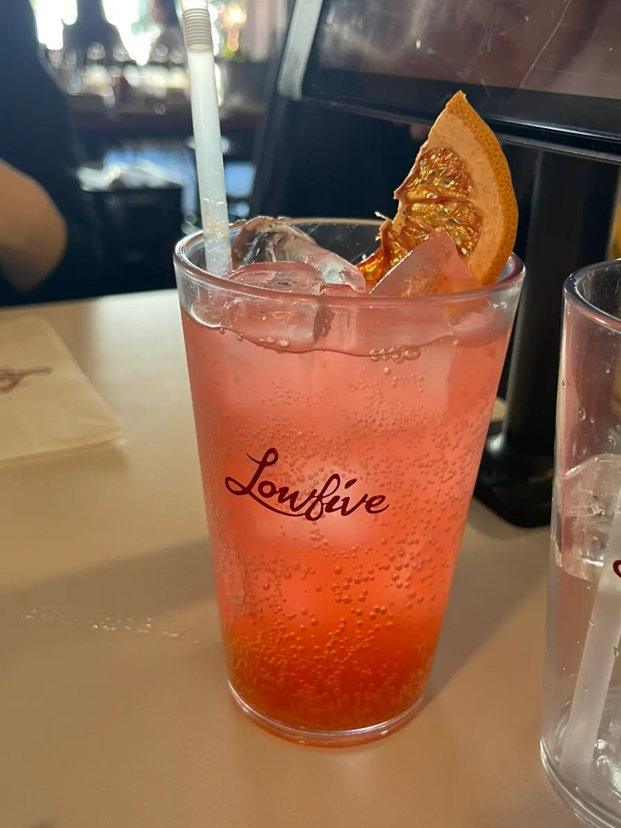 A glass of grapefruit ade full of ice