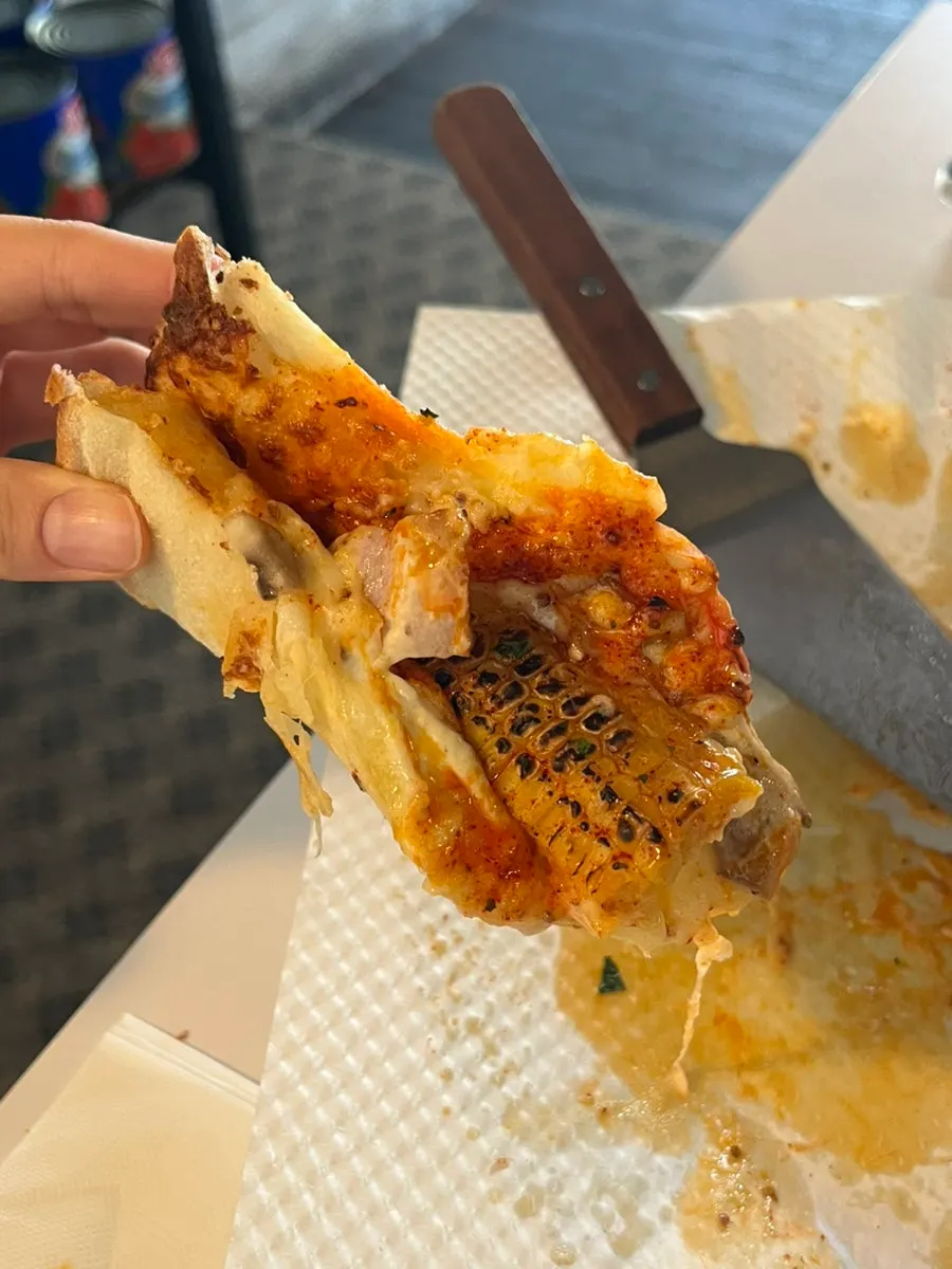 A slice of the cream sauce corn pizza