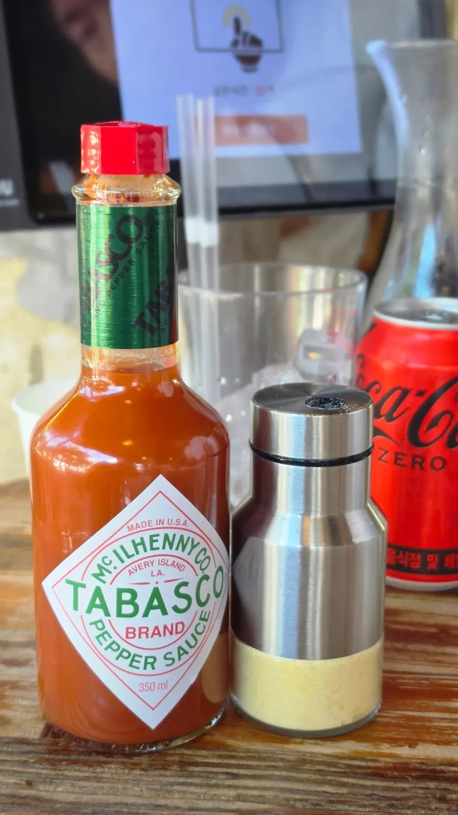 Hot sauce and cheese powder at the self-serve bar