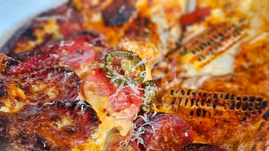 Sliced jalapeños on top of the pizza