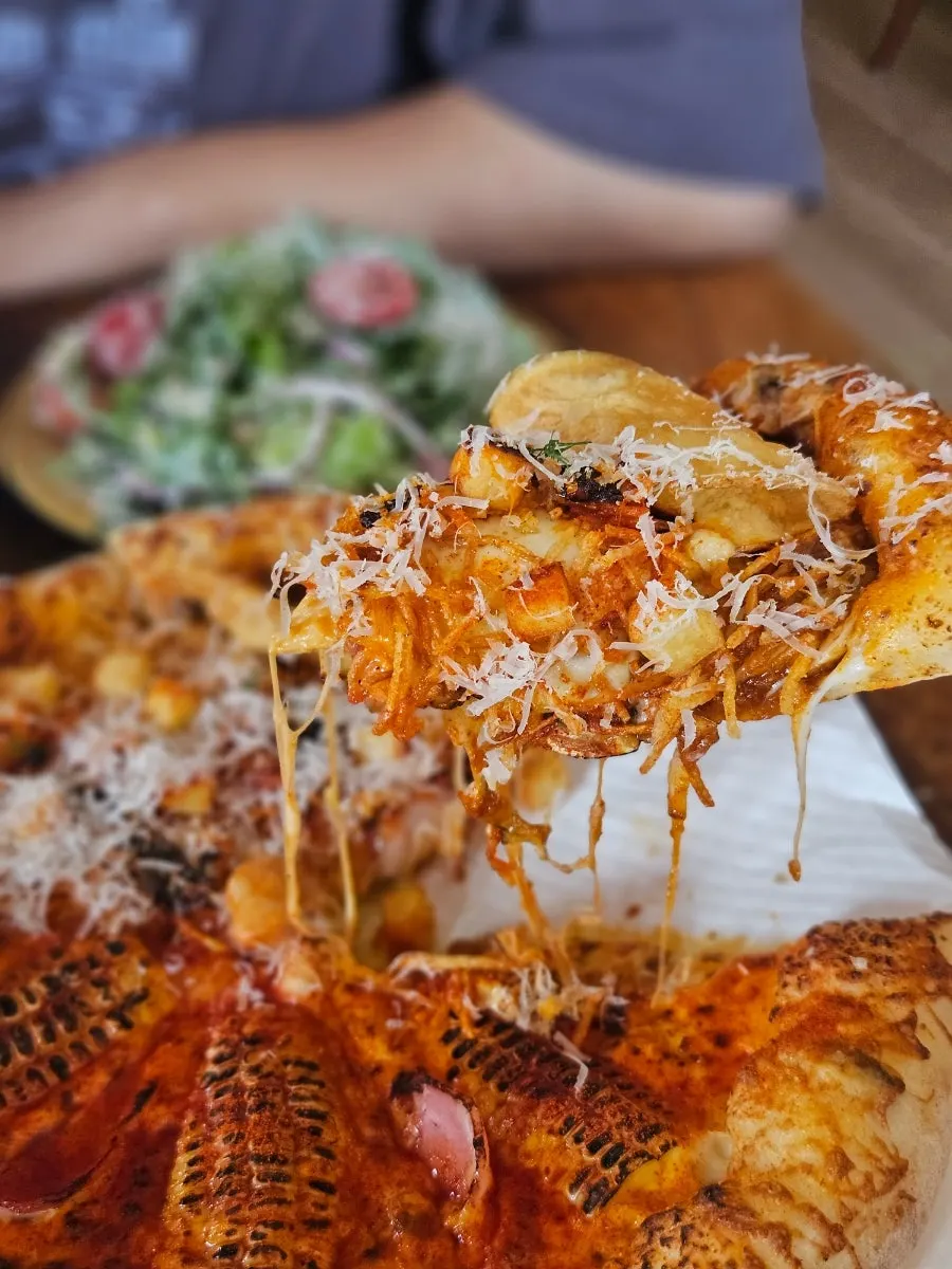 Close-up of the pizza split into two halves
