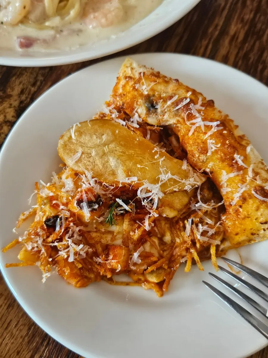 Slice of hot chili potato pizza loaded with potato toppings