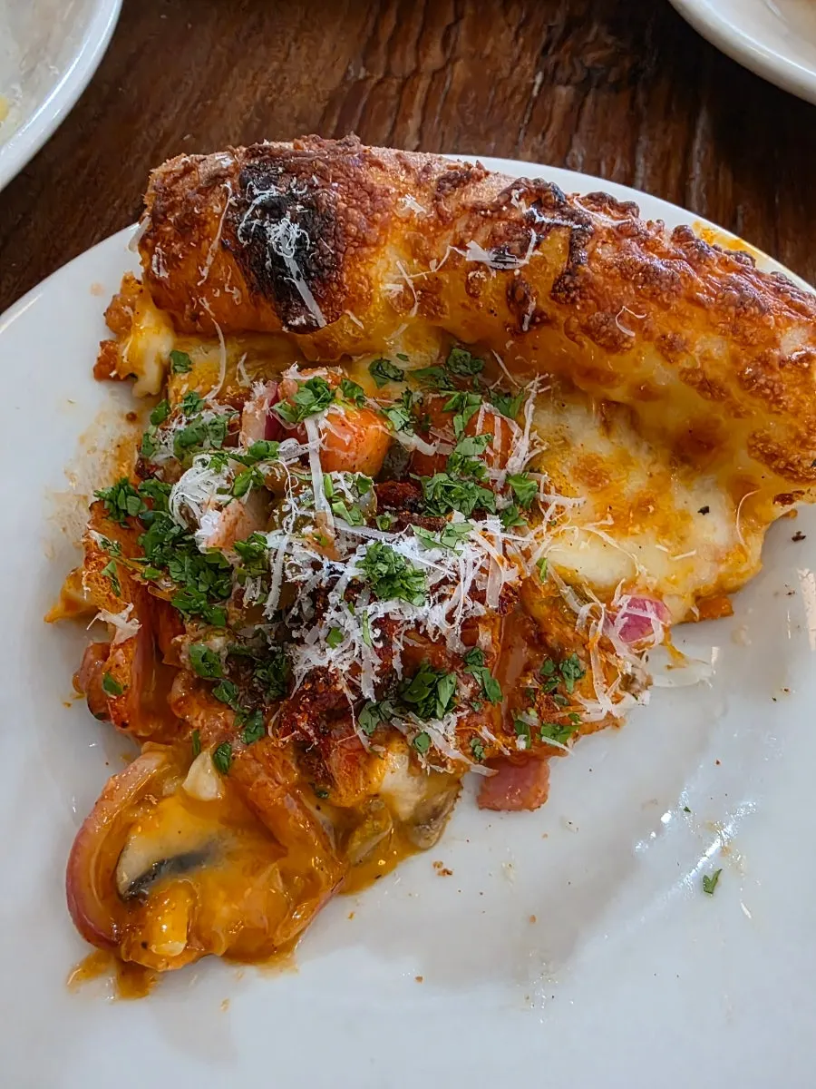 Close-up of a spicy slice of taco pizza