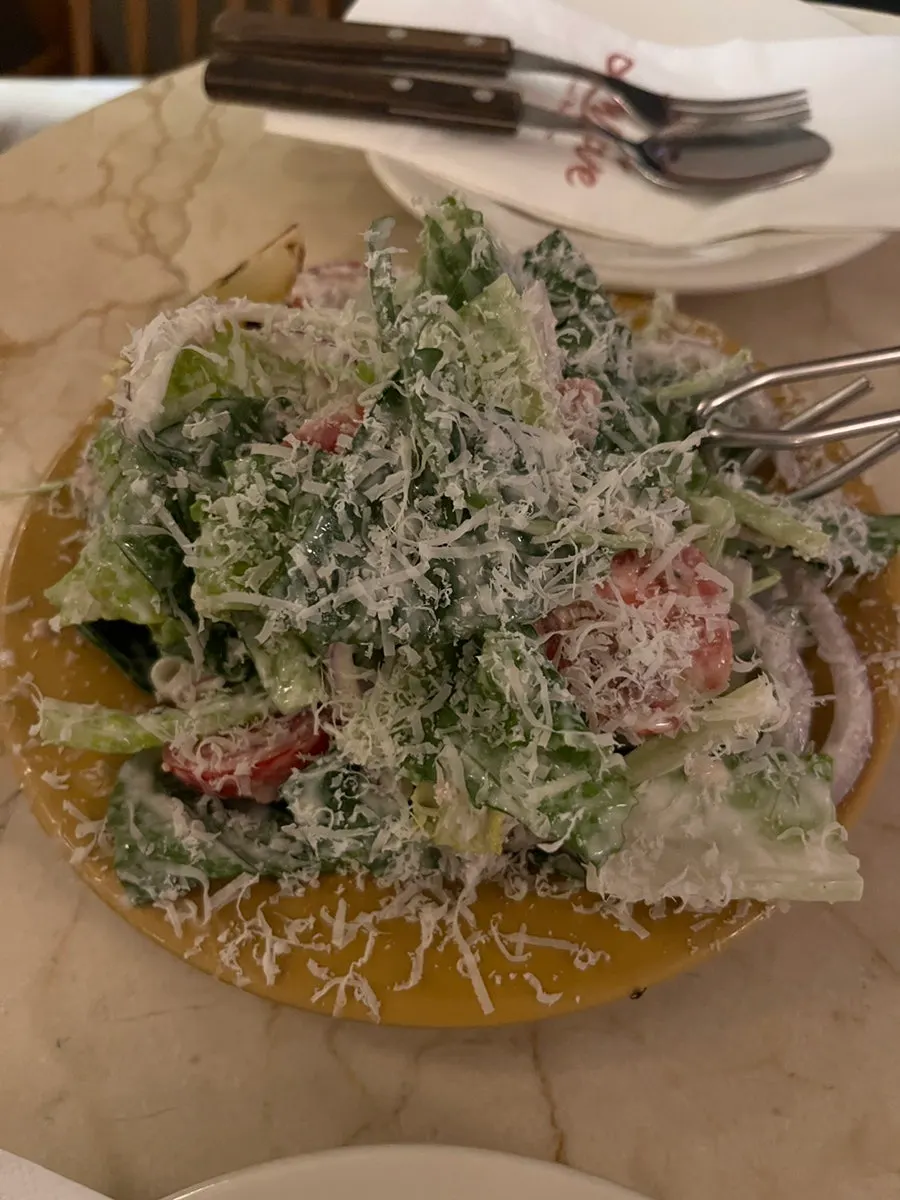 Classic Caesar salad served with dressing already mixed in