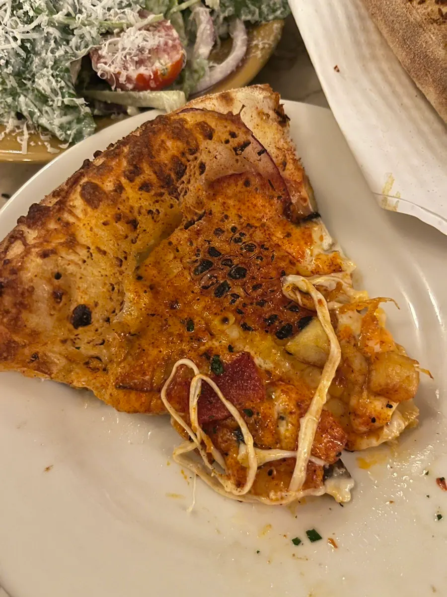 Signature corn pizza topped with sliced whole corn kernels