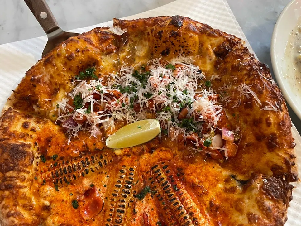 Close-up of the half-and-half pizza split into two halves
