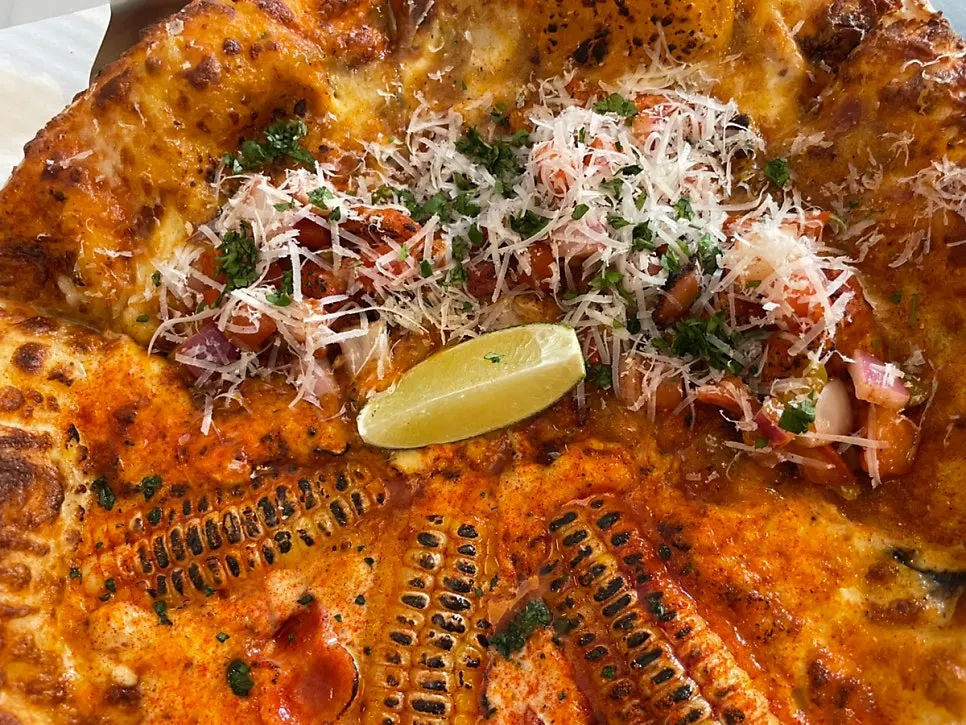 Corn pizza topped with corn and chili shrimp