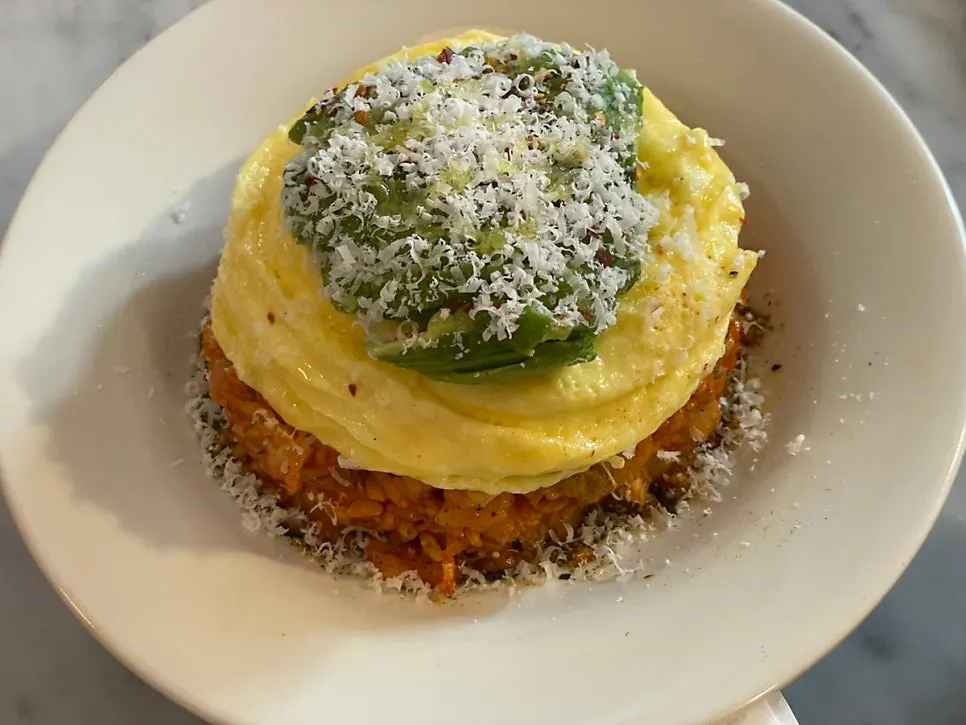 Kimchi fried rice topped with scrambled egg and avocado