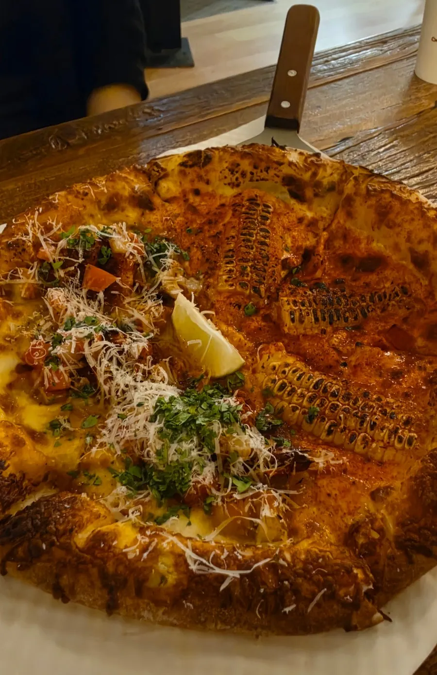 A whole half-and-half corn and taco pizza
