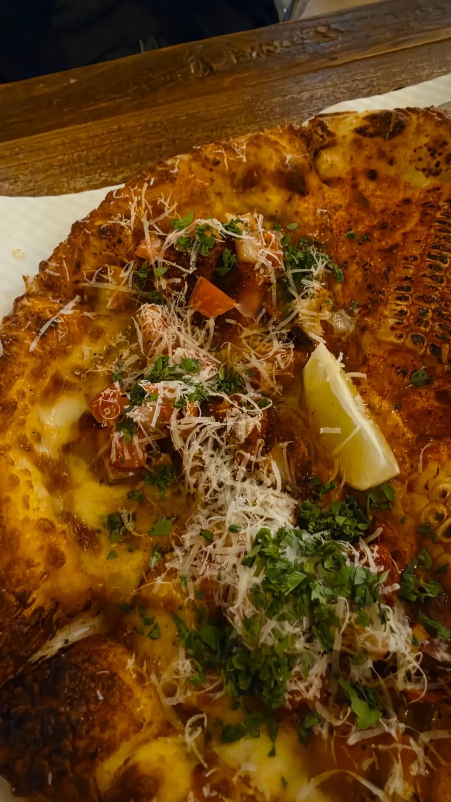 A slice of taco pizza sprinkled with cilantro