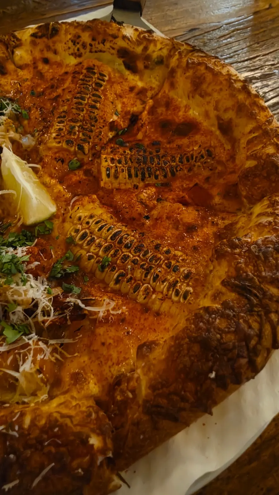 A slice of pizza topped with corn
