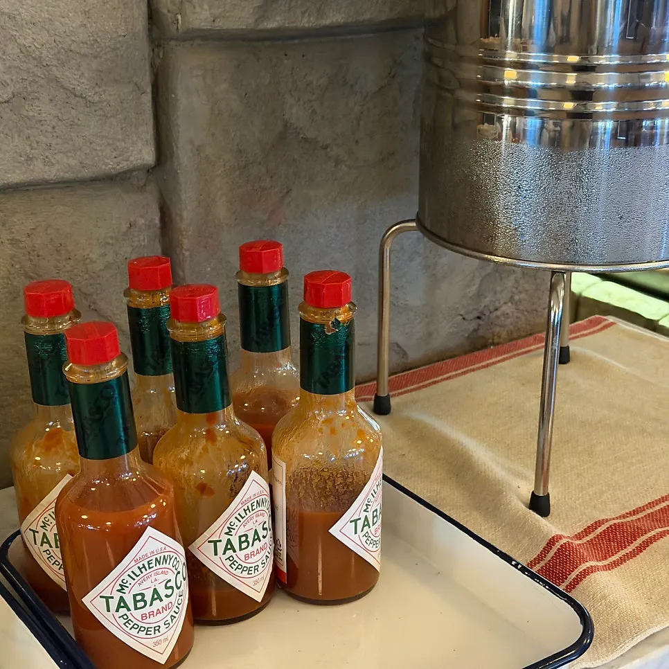 Parmesan cheese and tabasco sauce at the self-serve bar