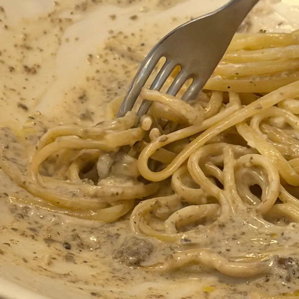 Truffle cream pasta drizzled with truffle oil