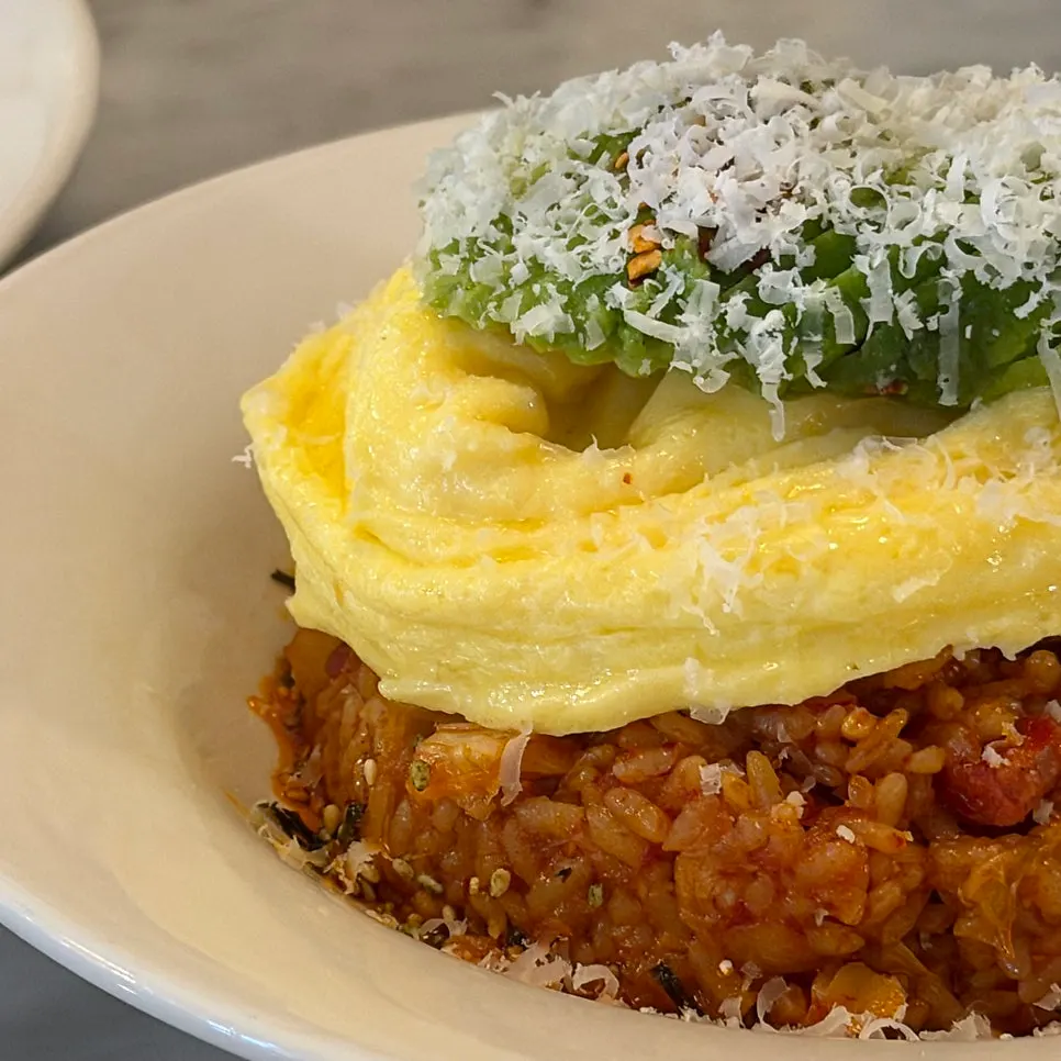 Kimchi fried rice topped with avocado and scrambled eggs