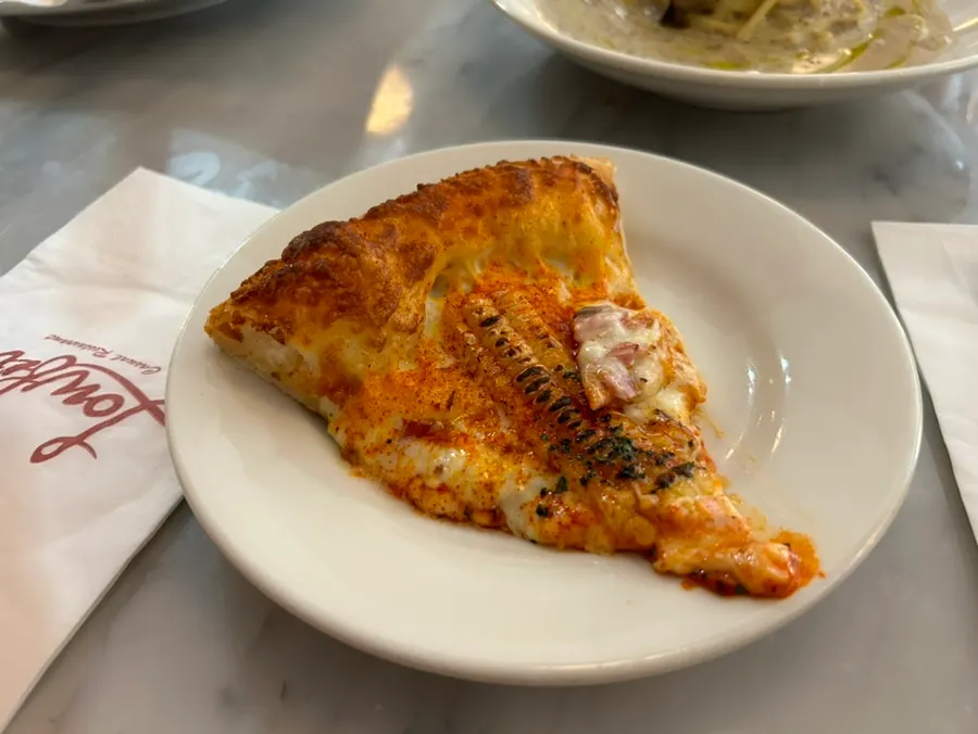 Corn pizza piled high with corn kernels