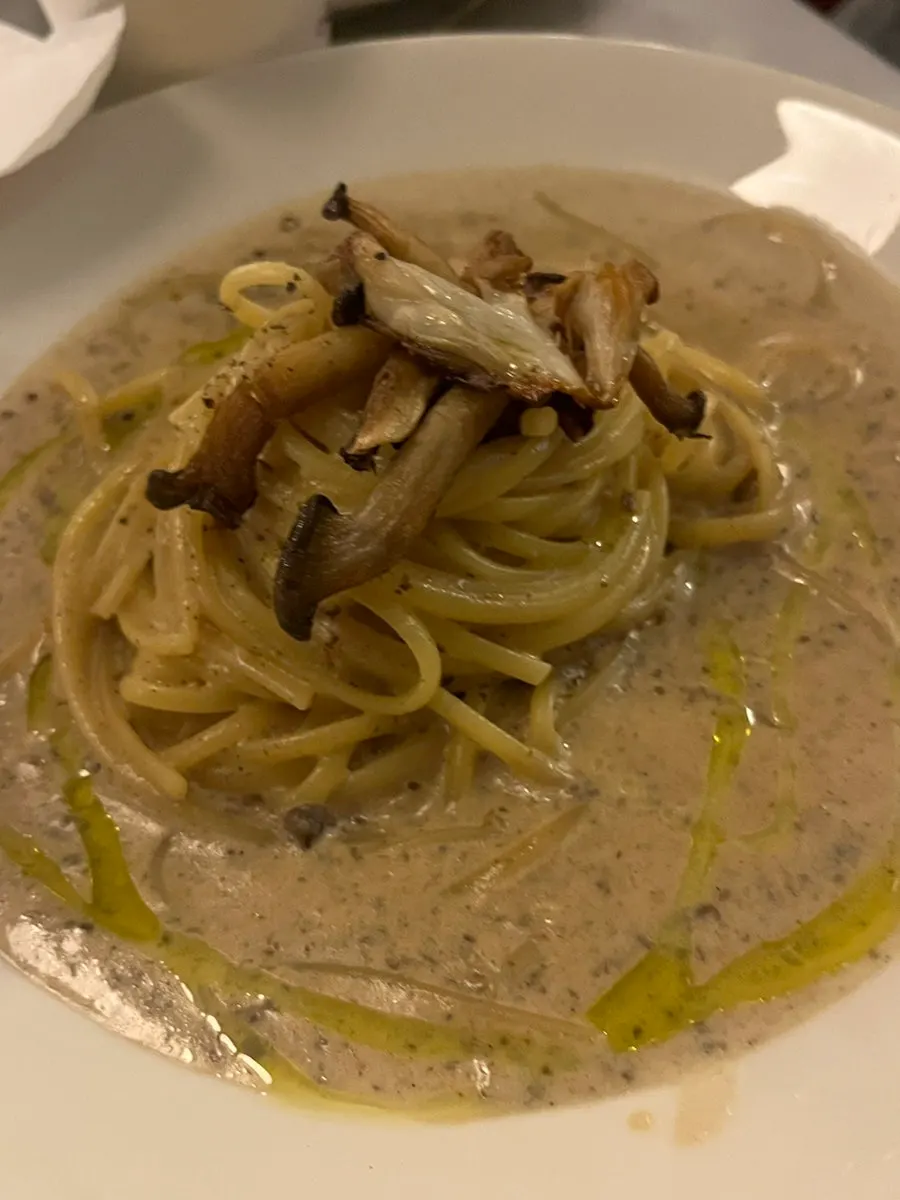 Dipping pizza dough into truffle cream sauce