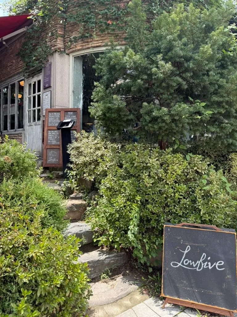 Plant-decorated exterior and entrance of Low Five