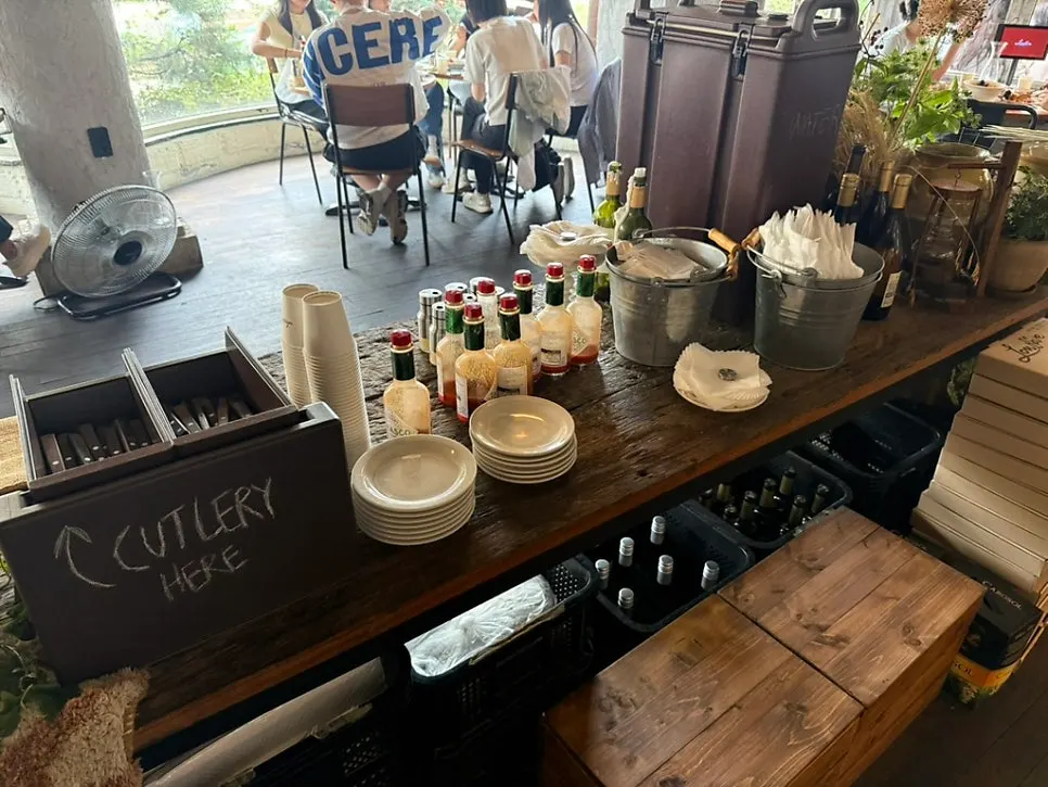 Self-service corner with hot sauce and plates