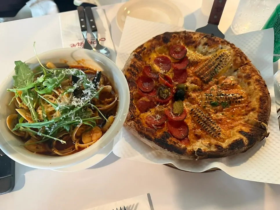 Table with pizza and pasta placed together