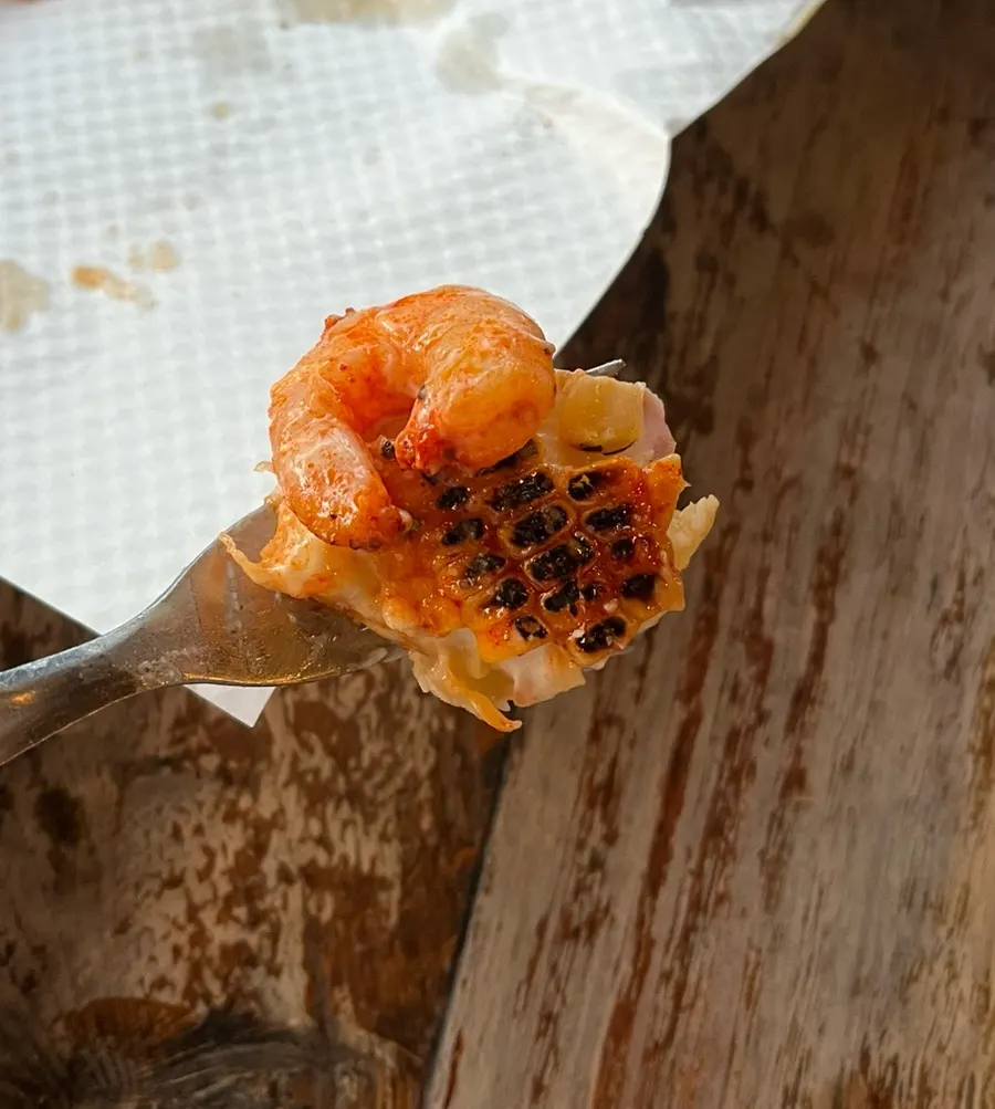 A cheesy pizza slice being pulled apart