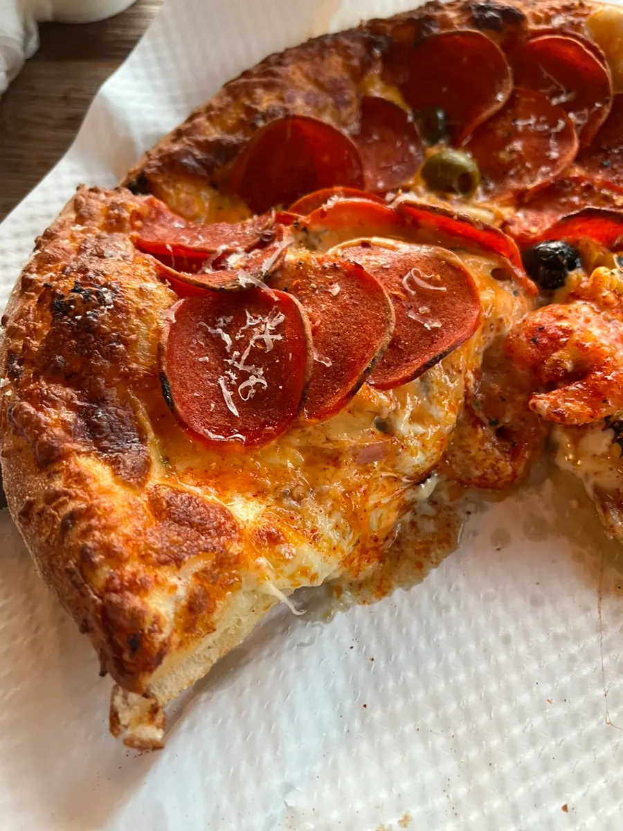 Pepperoni pizza topped with olives