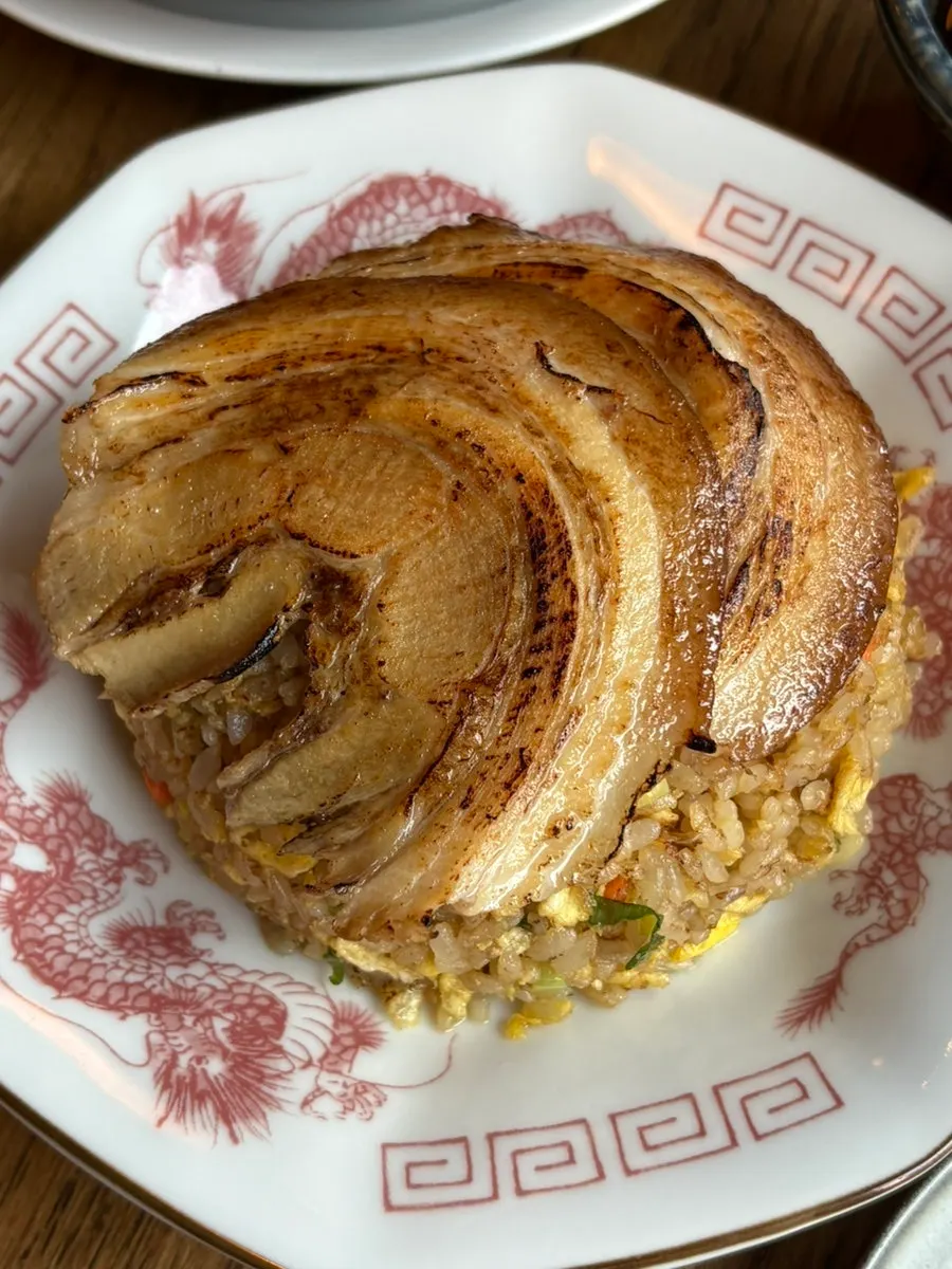 Char siu fried rice topped with two pieces of char siu
