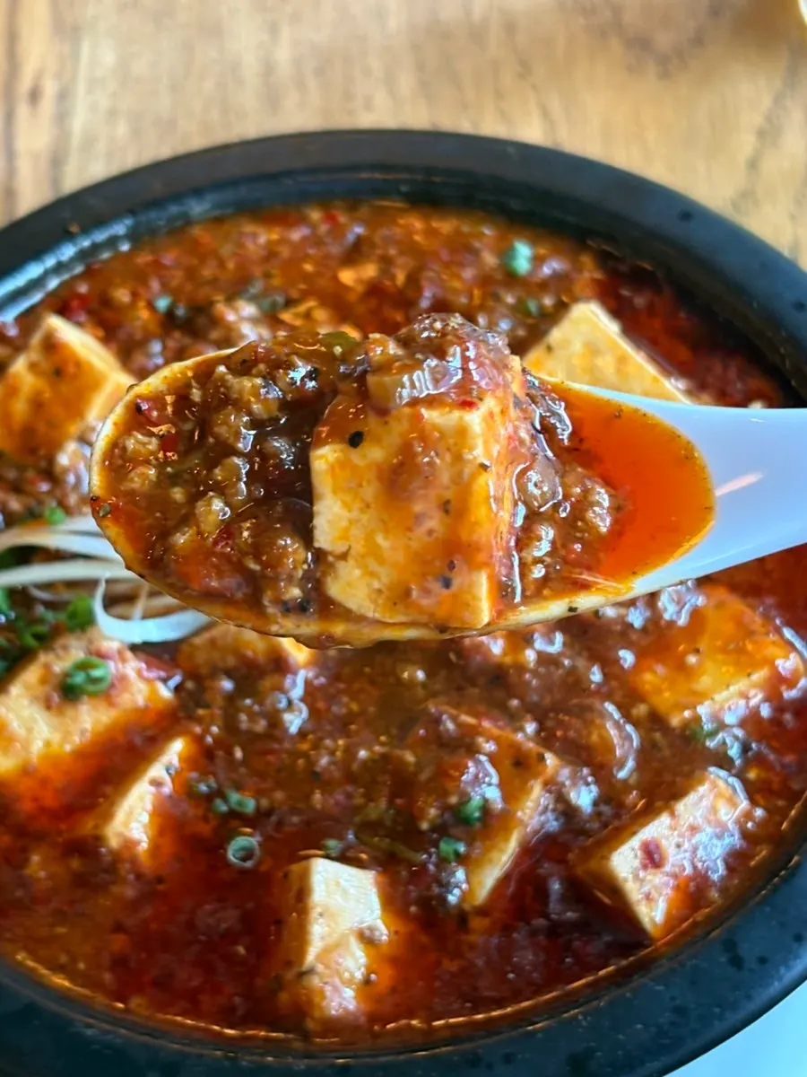 Mapo tofu spooned over fried rice