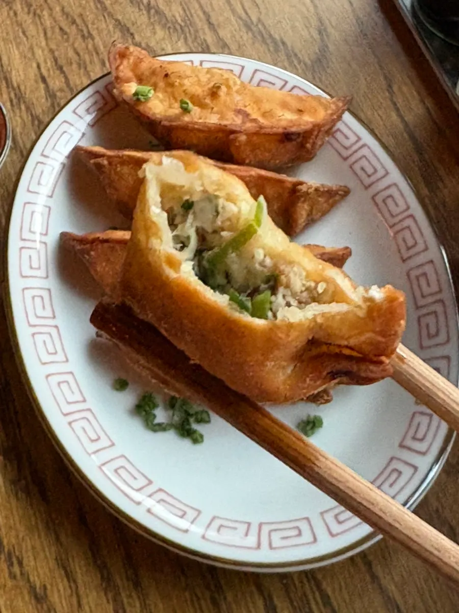 Yaki gyoza being dipped in sauce