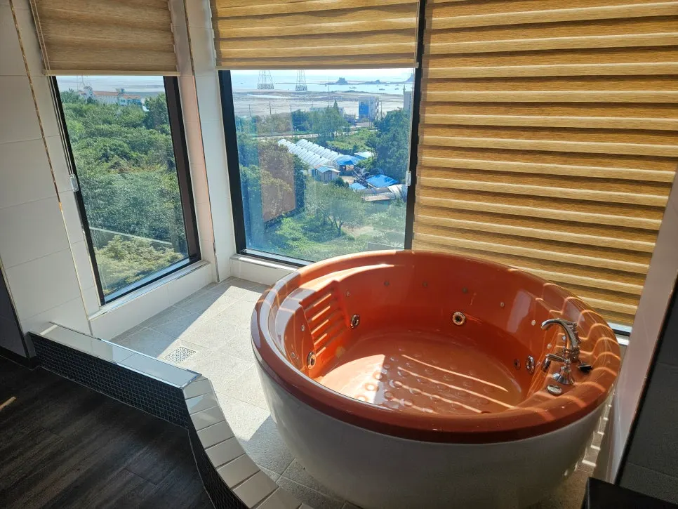Spa room bathtub with a view of the mudflats outside