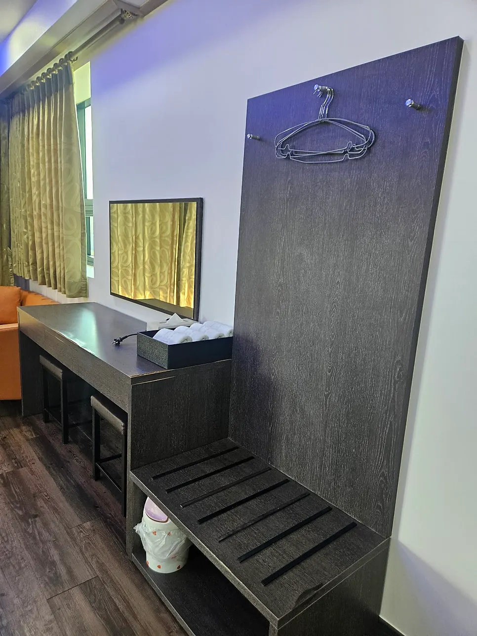 Room vanity with a large mirror and shelving