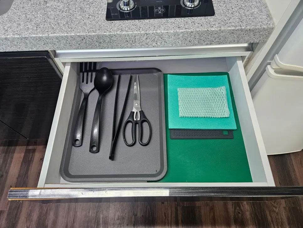 Kitchen drawer with cutting board and cooking tools