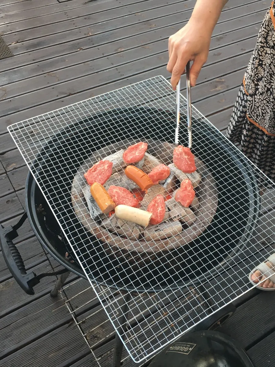 Outdoor barbecue spot and grill next to the pool