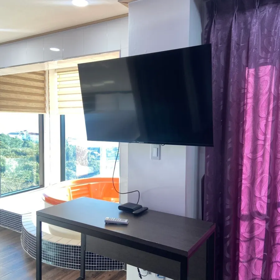 Pension-style room interior with a table and kitchen
