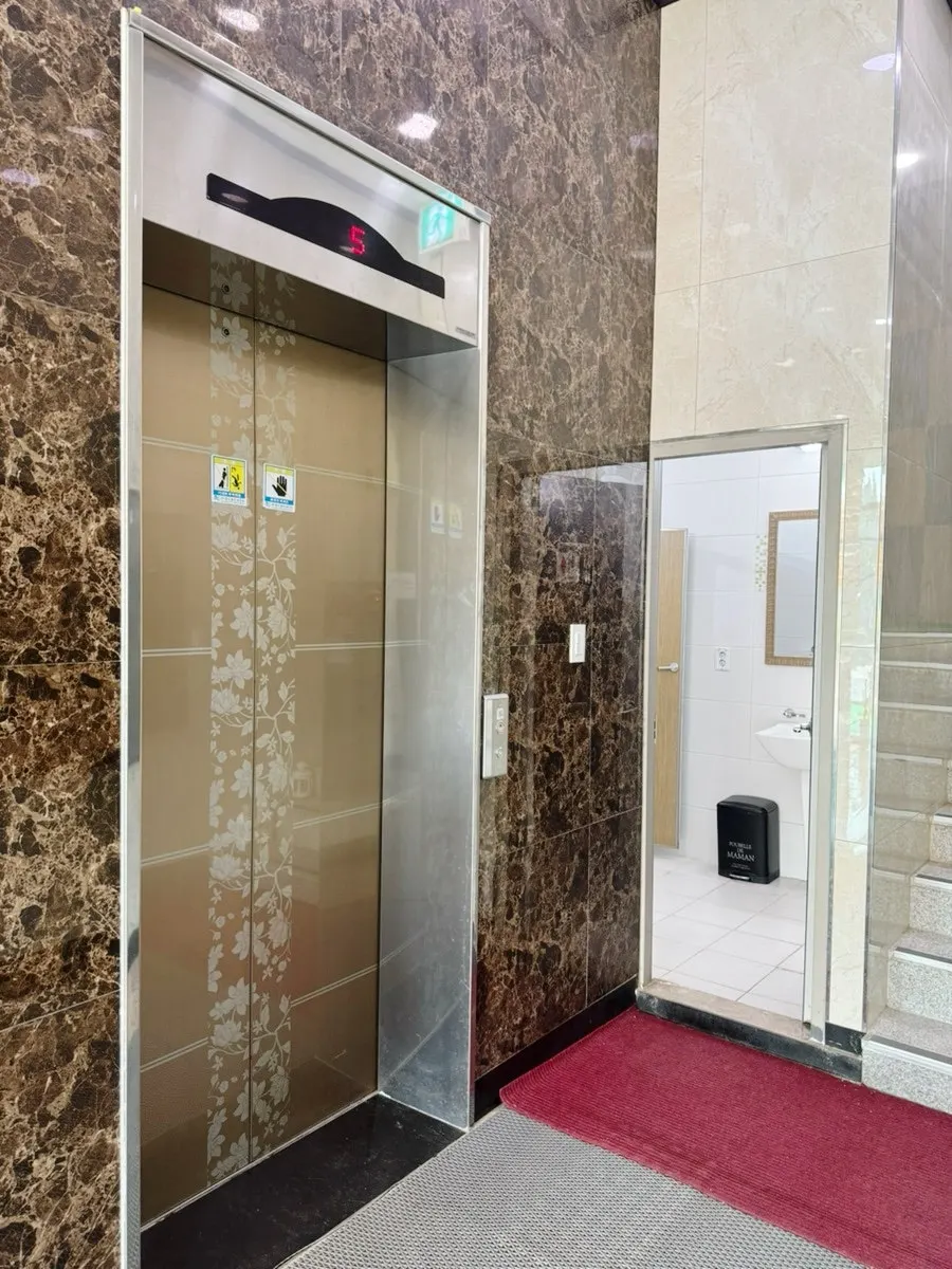 Amenity shelf next to the lobby desk with waste pads and spare towels