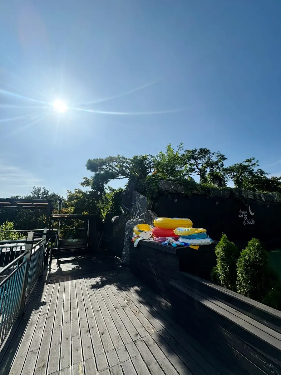Swing and gazebo-style resting spot near the pool