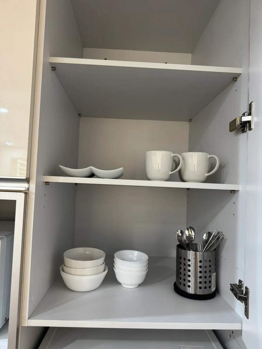 Room kitchen equipped with cookware and dishes