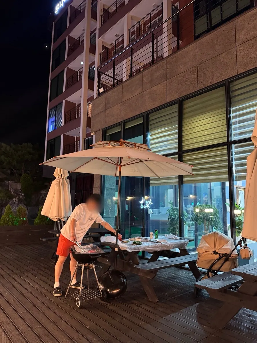 Outdoor barbecue deck lit up with parasols at night