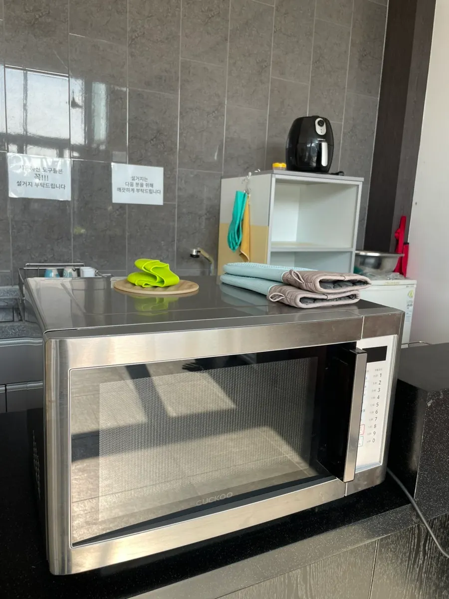Disposable plates and tongs set up in the shared kitchen