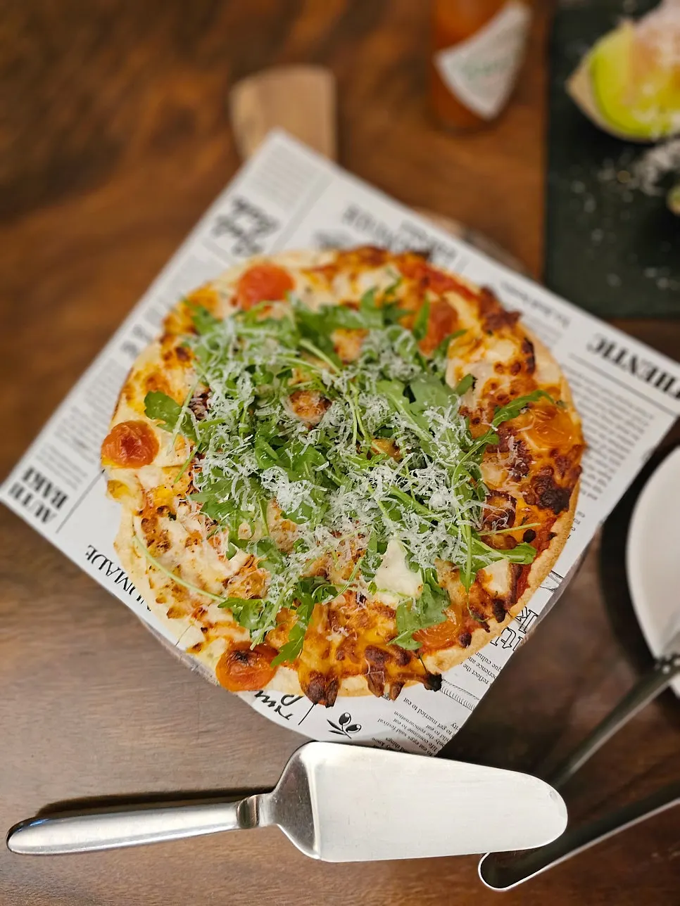 Margherita pizza topped with arugula and cheese
