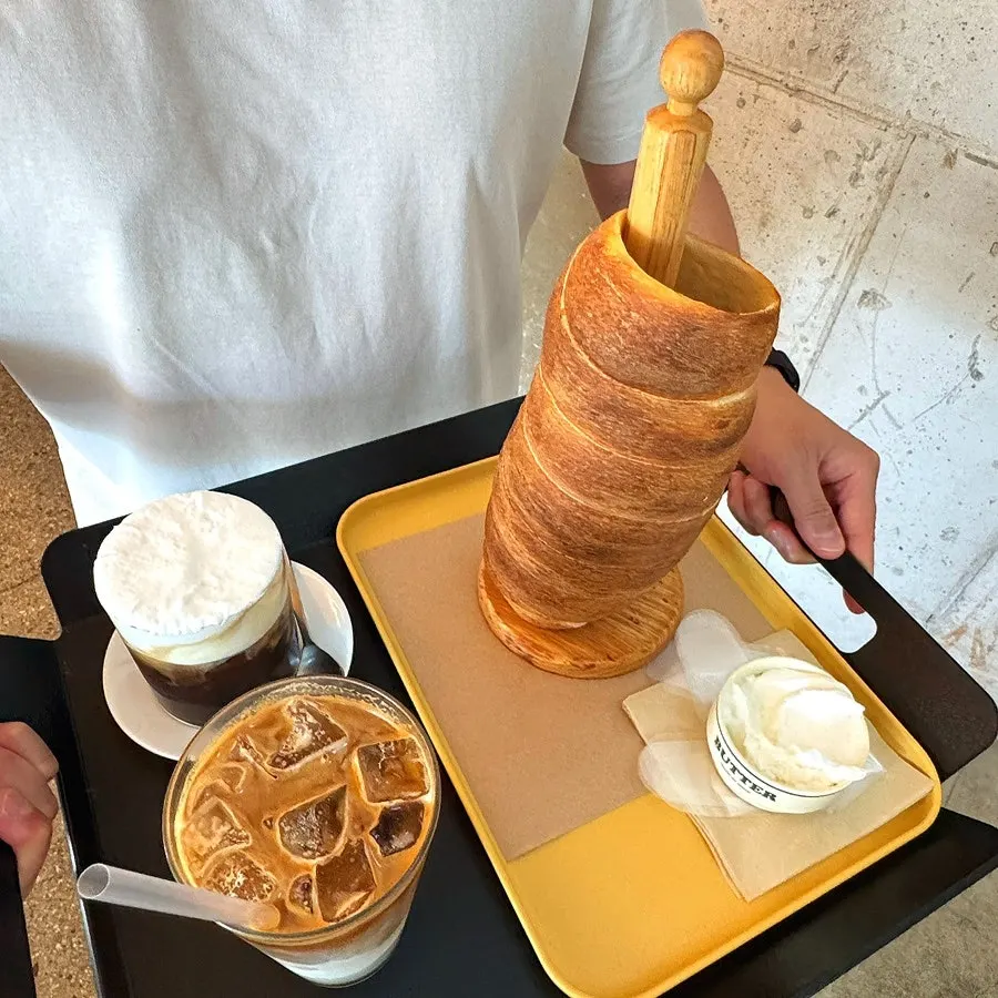 Dipping the chimney bread in whipped cream