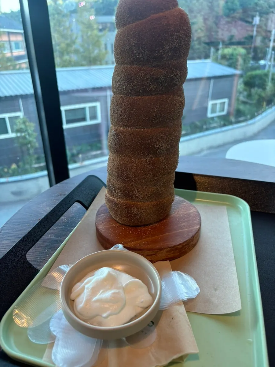 Cinnamon chimney bread standing on a wooden skewer