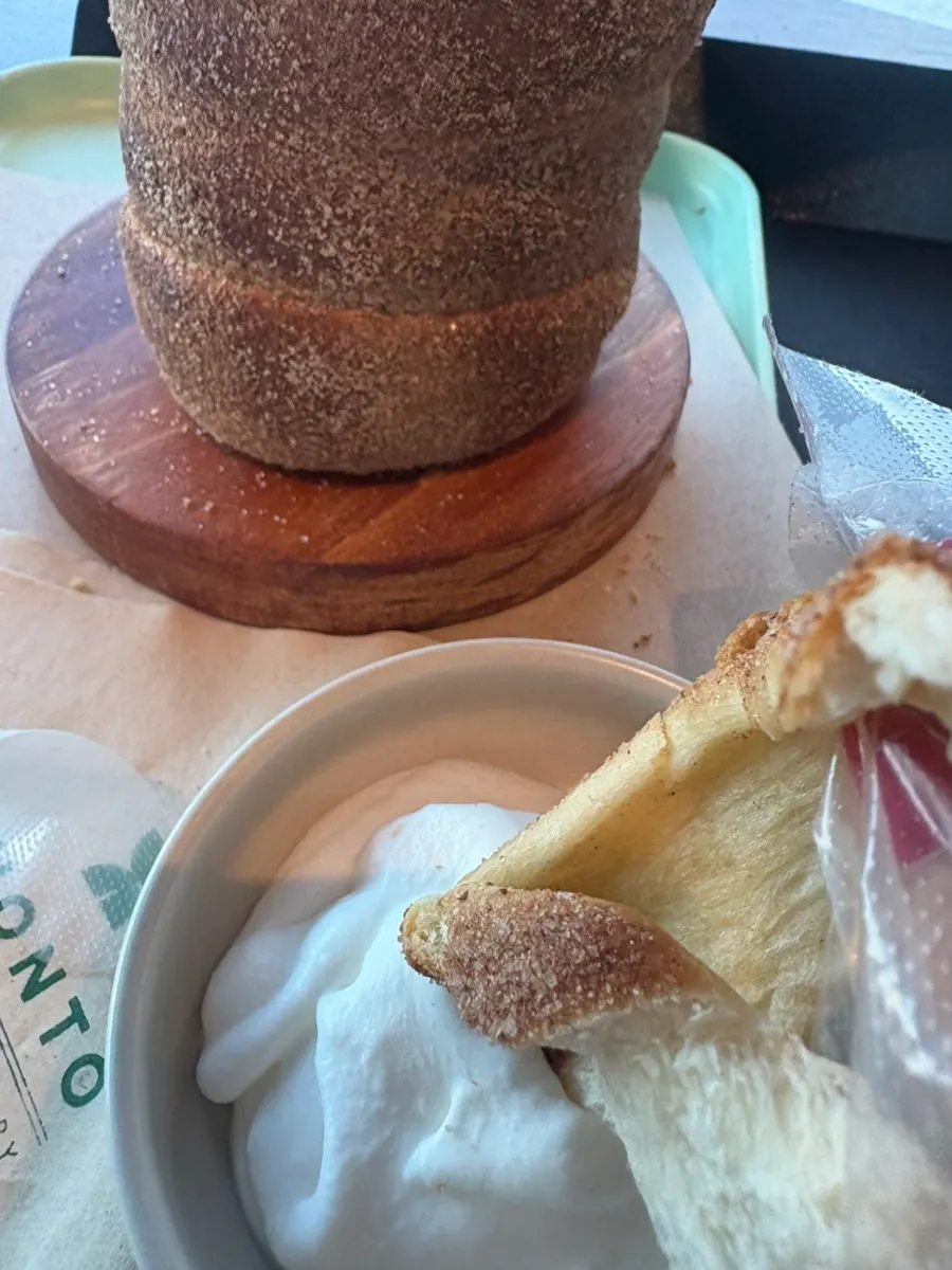 Whipped cream served alongside the chimney bread