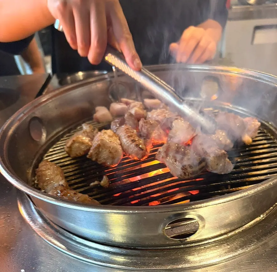A staff member showing the raw pork