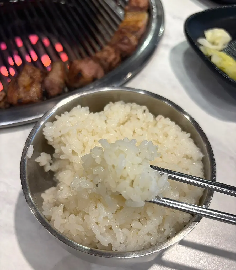 A bowl of Suhyangmi rice with accompanying dishes
