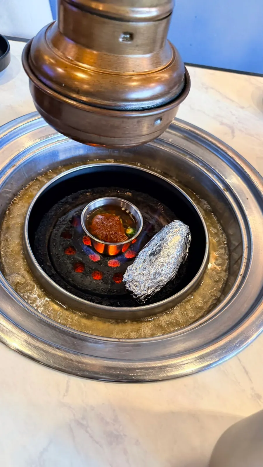 Mushrooms and meljeot placed on the charcoal grill