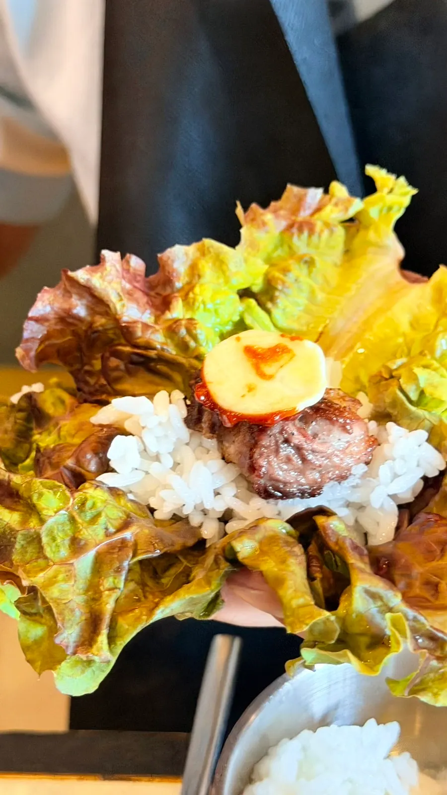 A piece of black pork dipped in sea salt and meljeot