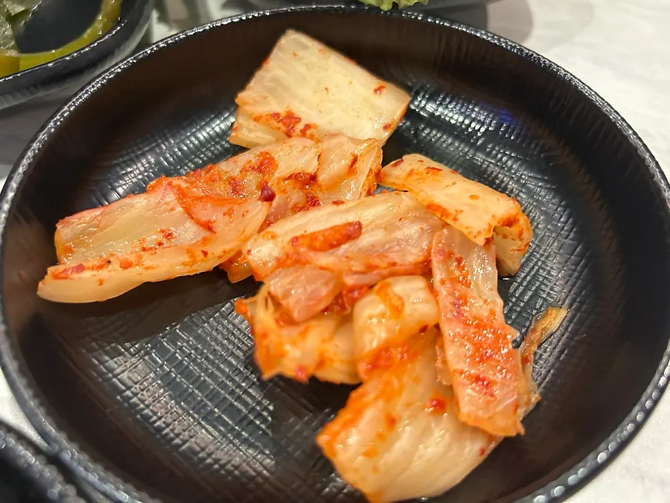 Close-up of pork neck cooking over high charcoal heat