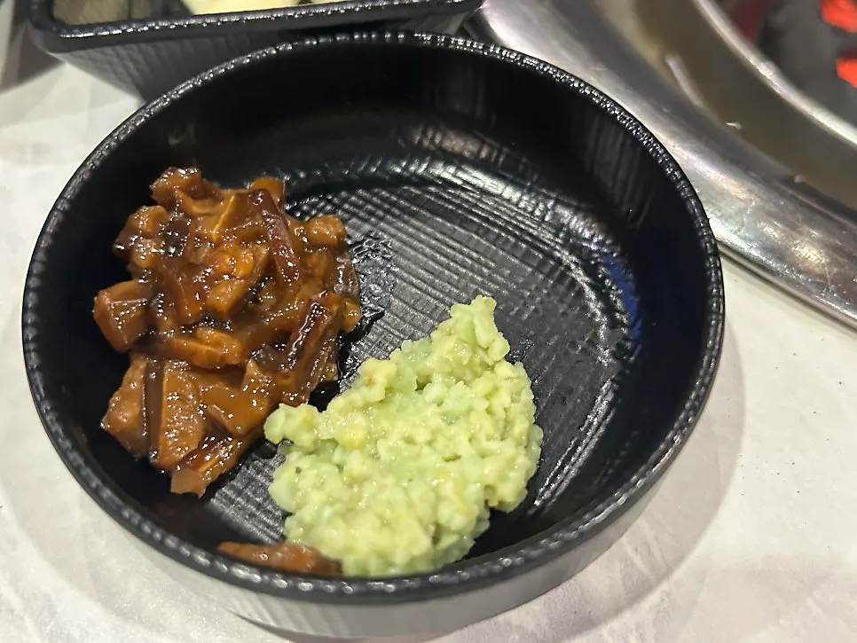 Grilled black pork neck arranged on the charcoal grill