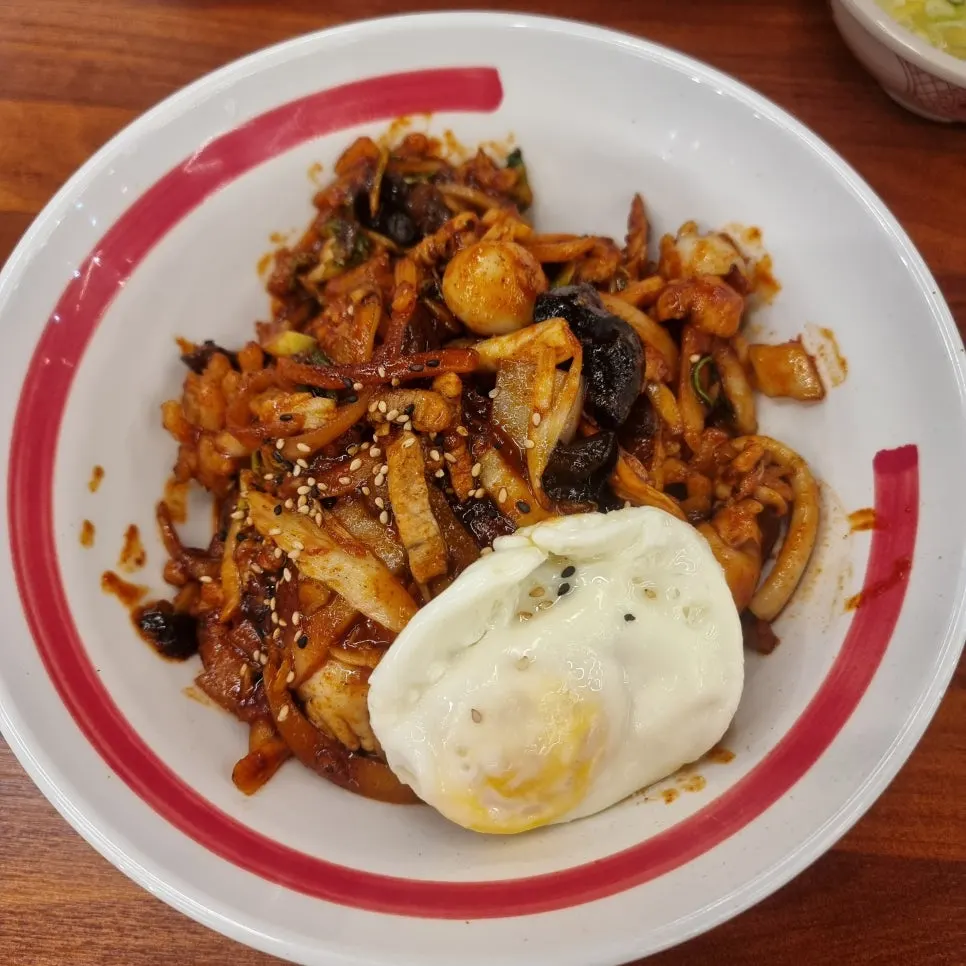 Chinese-style bibimbap topped with a fried egg
