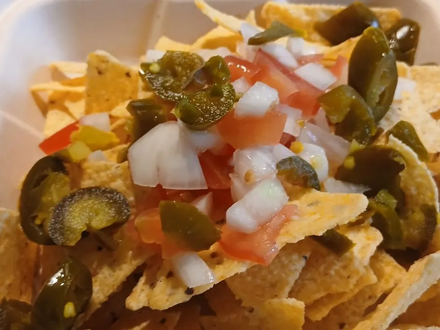 Opening the takeout container of meat sobo nachos